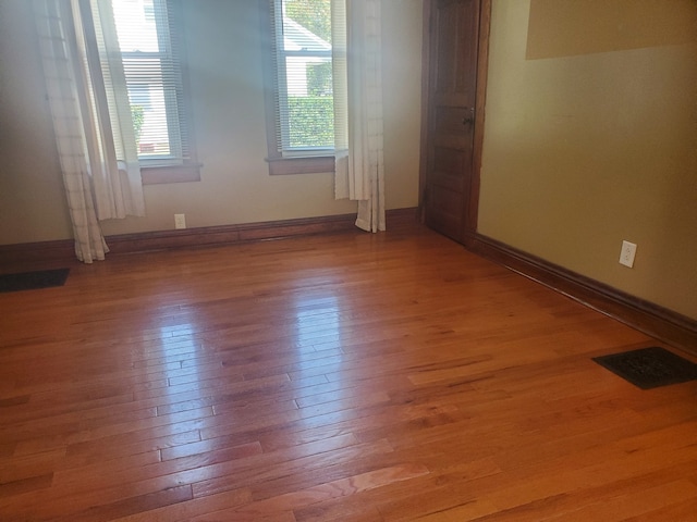 unfurnished room featuring hardwood / wood-style floors