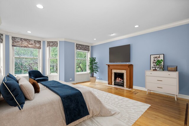 bedroom with light wood-type flooring and ornamental molding