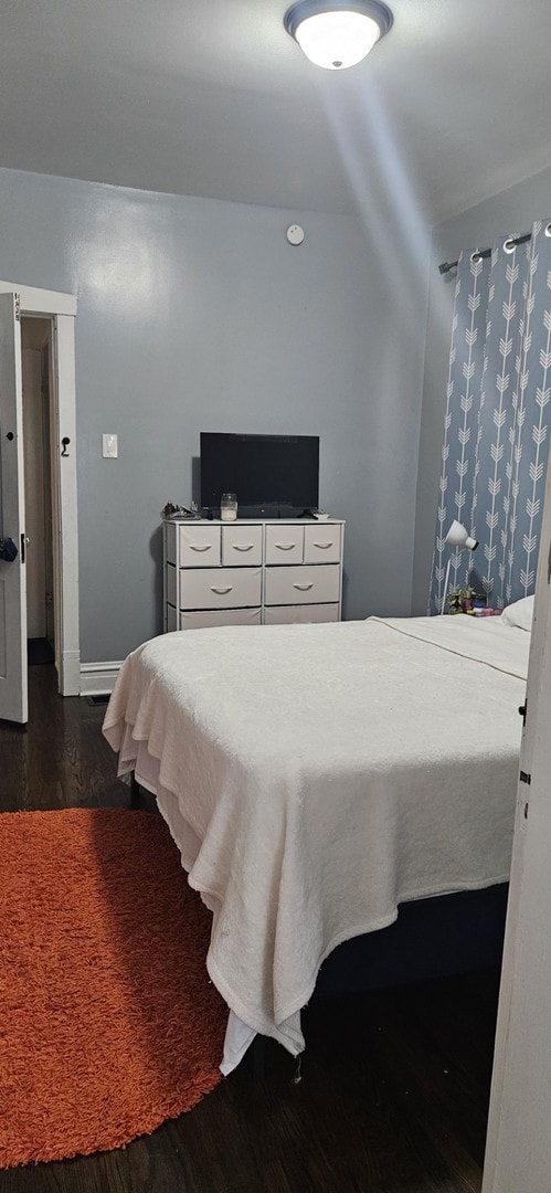 bedroom featuring dark hardwood / wood-style flooring