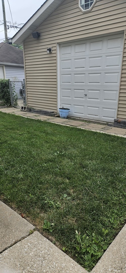 view of property exterior with a garage and a yard