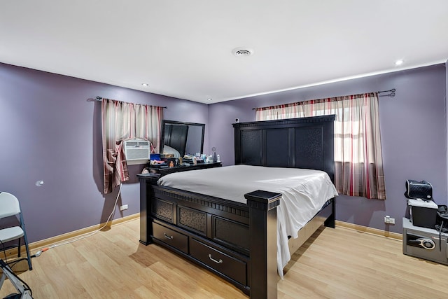 bedroom featuring light hardwood / wood-style flooring and cooling unit