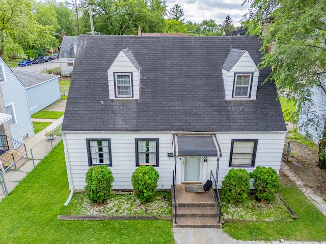 new england style home featuring a front lawn