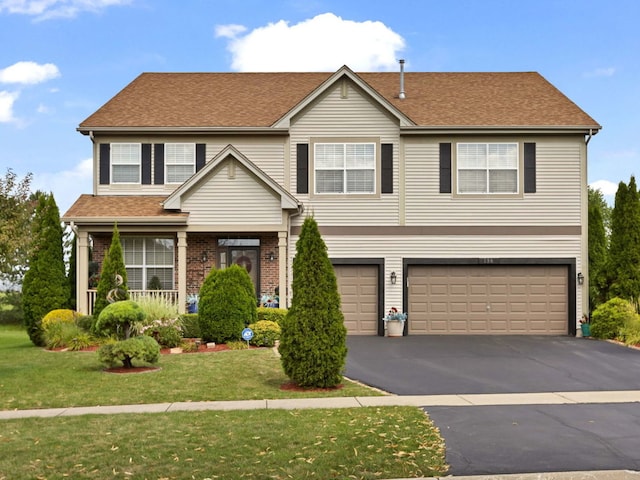 view of front of property with a front lawn and a garage