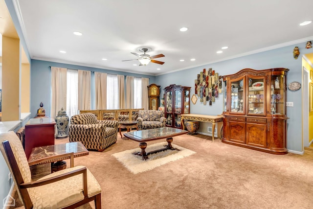 carpeted living room featuring ceiling fan and crown molding