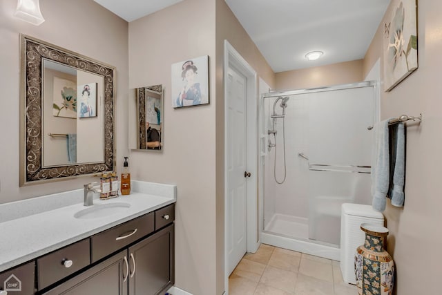 bathroom with vanity, a shower with door, and tile patterned floors