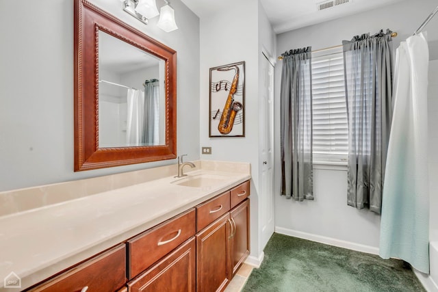 bathroom featuring vanity and a shower with shower curtain