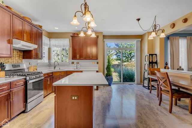 kitchen with an inviting chandelier, a center island, gas stove, and a wealth of natural light