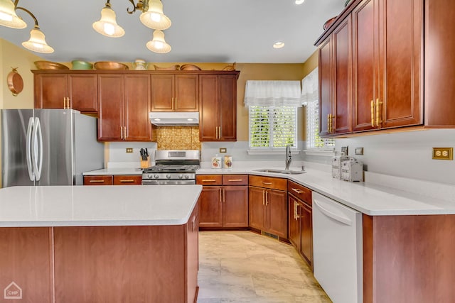 kitchen featuring hanging light fixtures, sink, appliances with stainless steel finishes, an inviting chandelier, and light stone countertops