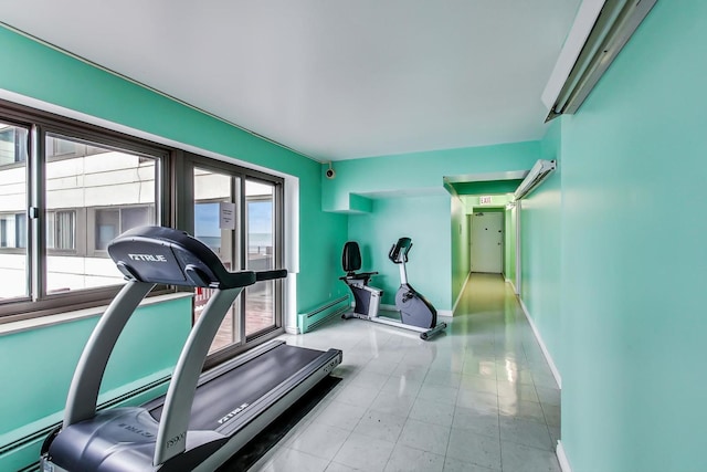 workout room with baseboard heating and light tile patterned floors