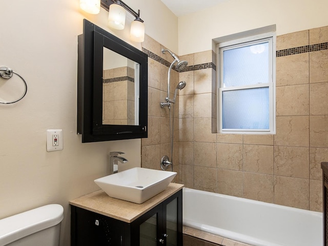 full bathroom featuring vanity, toilet, and tiled shower / bath combo