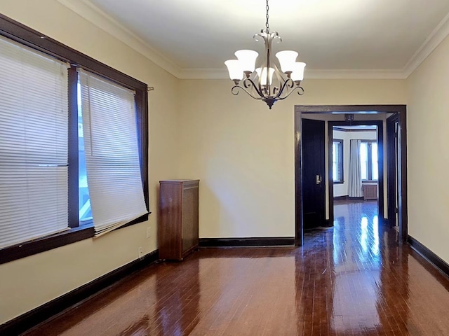 unfurnished room featuring crown molding, dark hardwood / wood-style flooring, radiator, and a chandelier