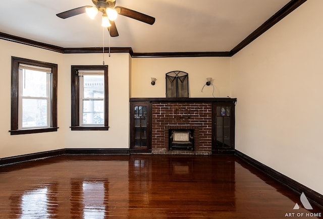 unfurnished living room featuring a fireplace, crown molding, and dark wood-type flooring