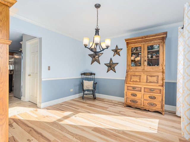 living area with an inviting chandelier, crown molding, and light wood-type flooring