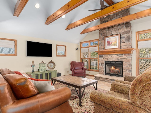 living room featuring beamed ceiling, ceiling fan, a stone fireplace, and high vaulted ceiling