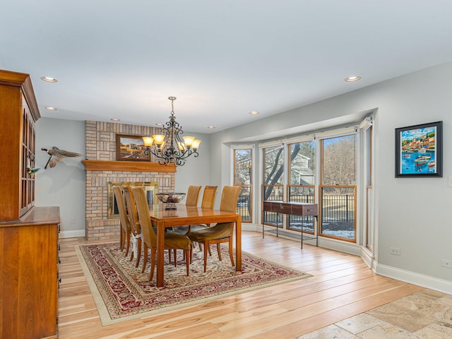 dining area featuring a notable chandelier and light hardwood / wood-style flooring