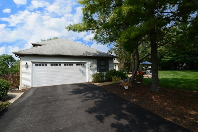 view of front of home with a garage and a front lawn