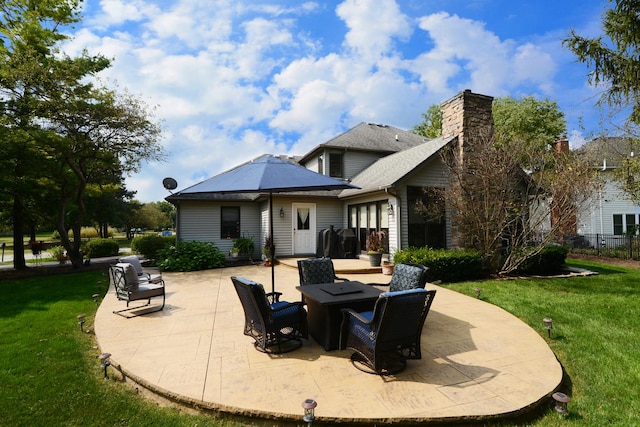 back of house featuring a lawn and a patio