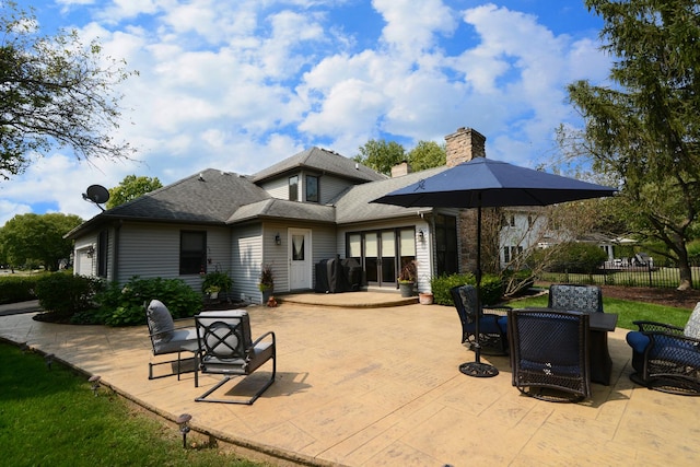 back of property with a patio