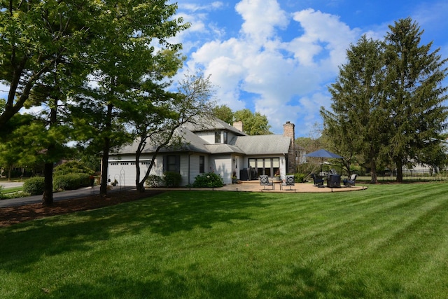 back of house featuring a yard and a patio