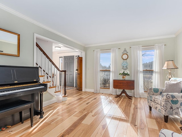 living area featuring ornamental molding and light wood-type flooring