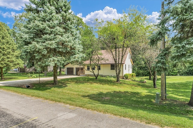 view of front of property featuring a front yard and a garage