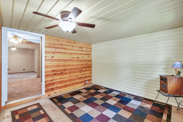 interior space featuring wooden walls and ceiling fan