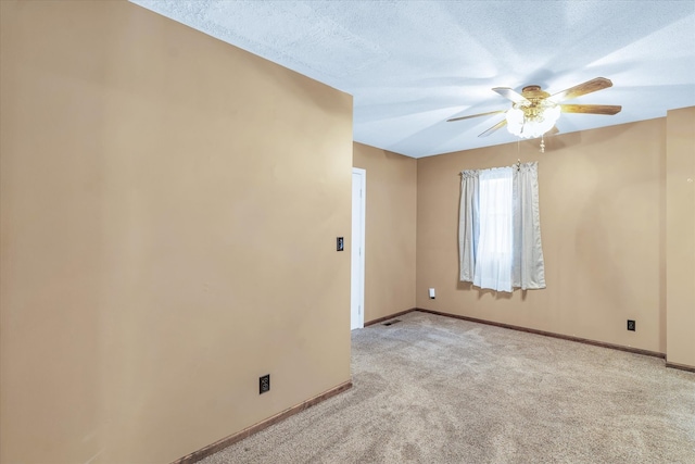 unfurnished room featuring a textured ceiling, ceiling fan, and light colored carpet