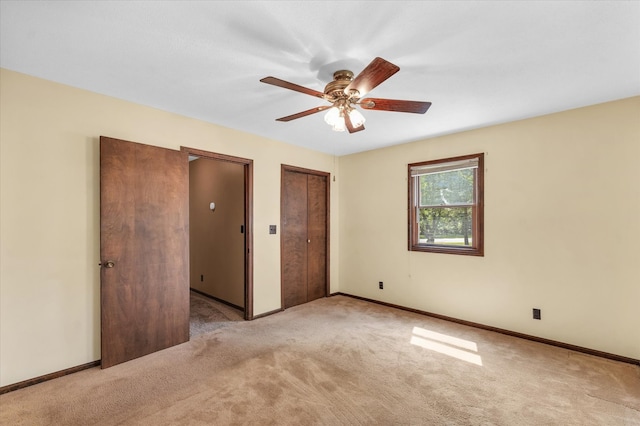 carpeted empty room featuring ceiling fan