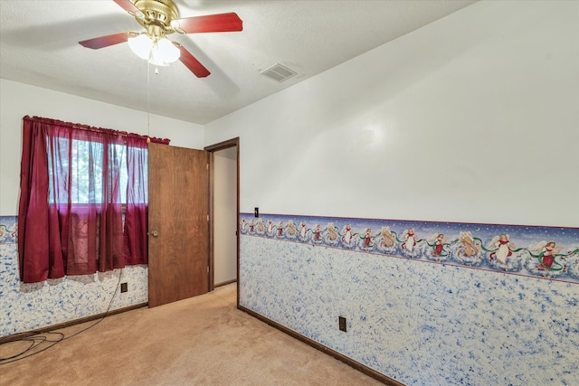 carpeted bedroom with a textured ceiling and ceiling fan