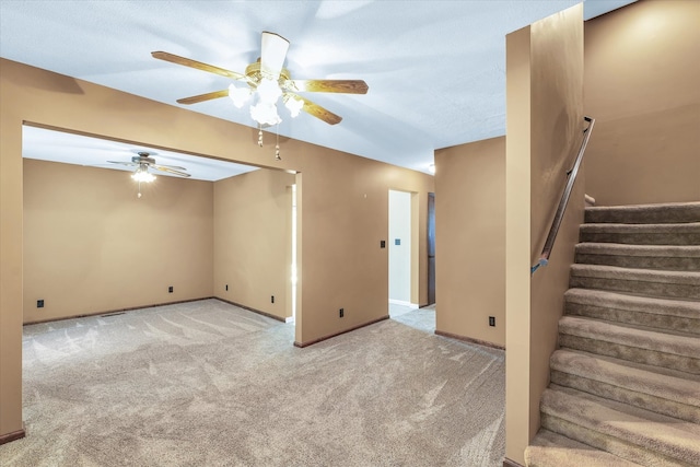 spare room featuring ceiling fan and light carpet