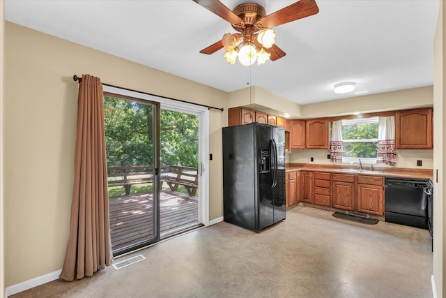 kitchen featuring ceiling fan, a wealth of natural light, sink, and black appliances