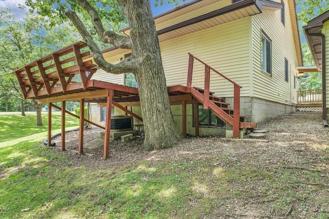 view of side of home featuring a deck and a yard