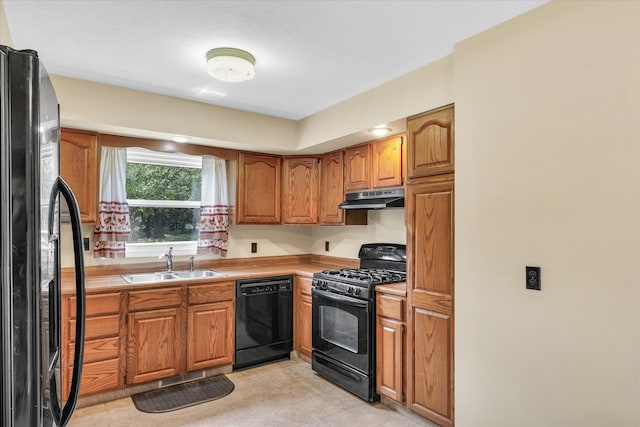 kitchen with light tile patterned floors, sink, and black appliances