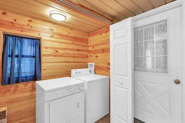 washroom with washing machine and dryer, wood walls, and wooden ceiling