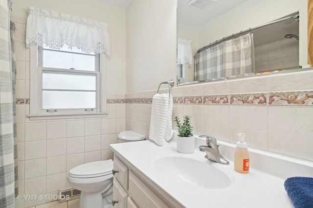 bathroom with toilet, vanity, tile walls, and a shower with shower curtain