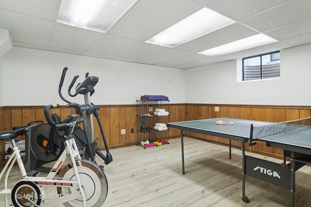 rec room featuring light wood-type flooring and a drop ceiling