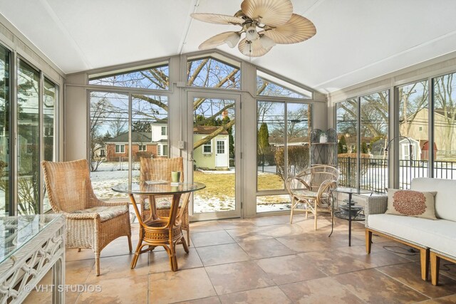 sunroom featuring vaulted ceiling and ceiling fan