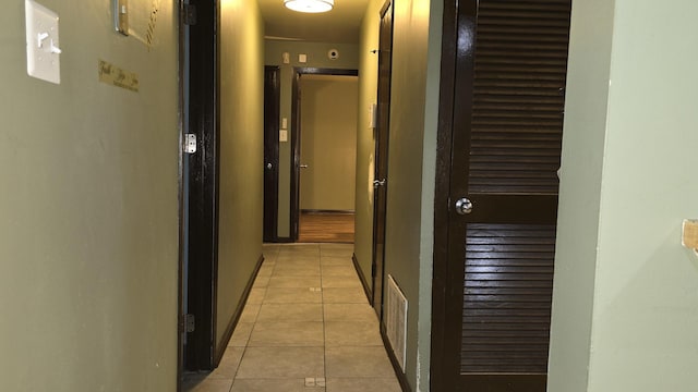 corridor featuring light tile patterned flooring