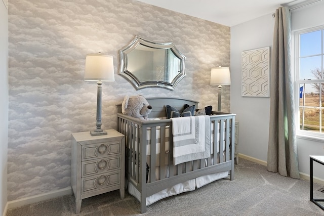 bedroom with carpet floors and a nursery area