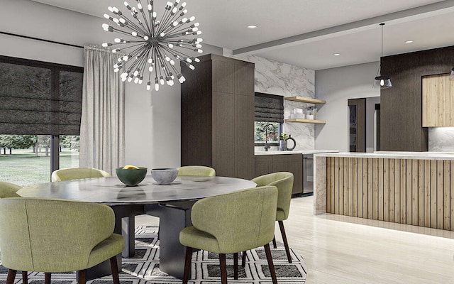 dining space featuring a notable chandelier and light wood-type flooring