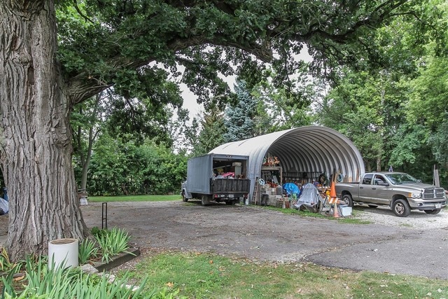 view of vehicle parking featuring a carport