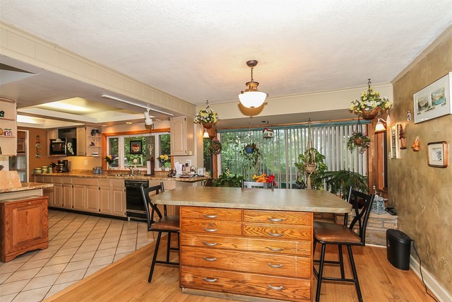 kitchen featuring sink, light wood-type flooring, a kitchen bar, and dishwasher