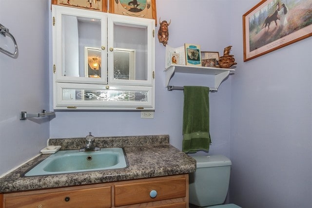 bathroom featuring toilet and vanity