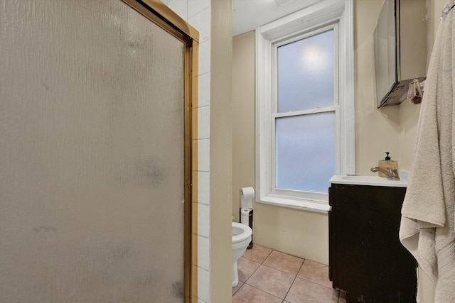 bathroom with toilet, an enclosed shower, vanity, and tile patterned flooring