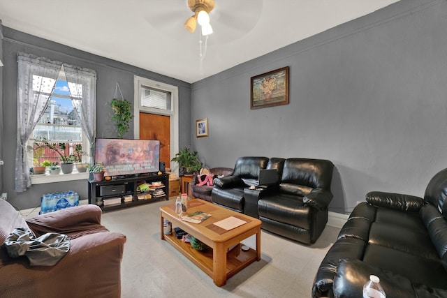 living room with ceiling fan and light tile patterned floors