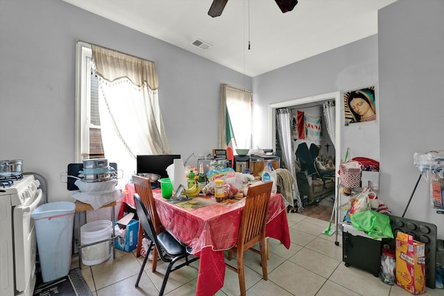 tiled dining area featuring ceiling fan, separate washer and dryer, and a healthy amount of sunlight