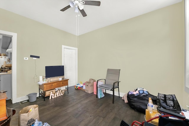 interior space with a high ceiling, ceiling fan, and dark hardwood / wood-style floors