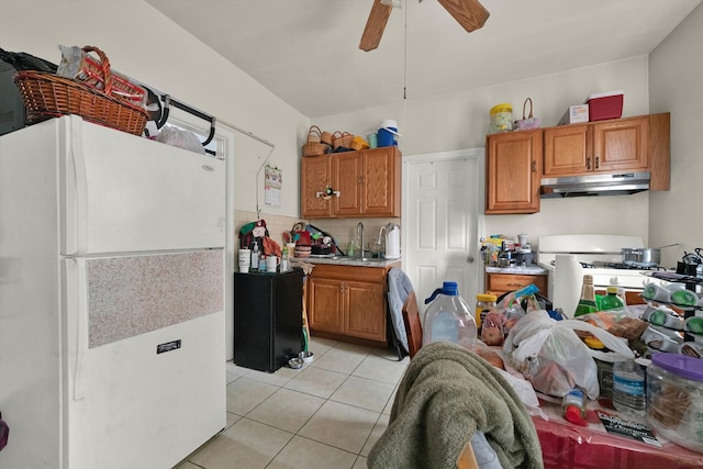 kitchen featuring white appliances, light tile patterned floors, sink, and ceiling fan