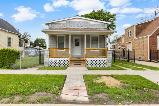 bungalow-style house featuring a front yard and covered porch