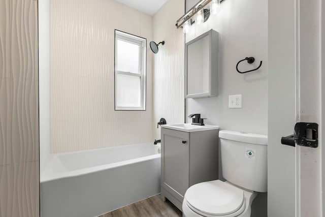 full bathroom with vanity, toilet, a healthy amount of sunlight, and wood-type flooring